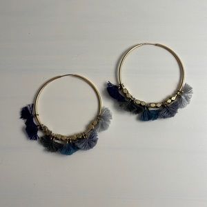 Gold hoop earrings with thread pompoms